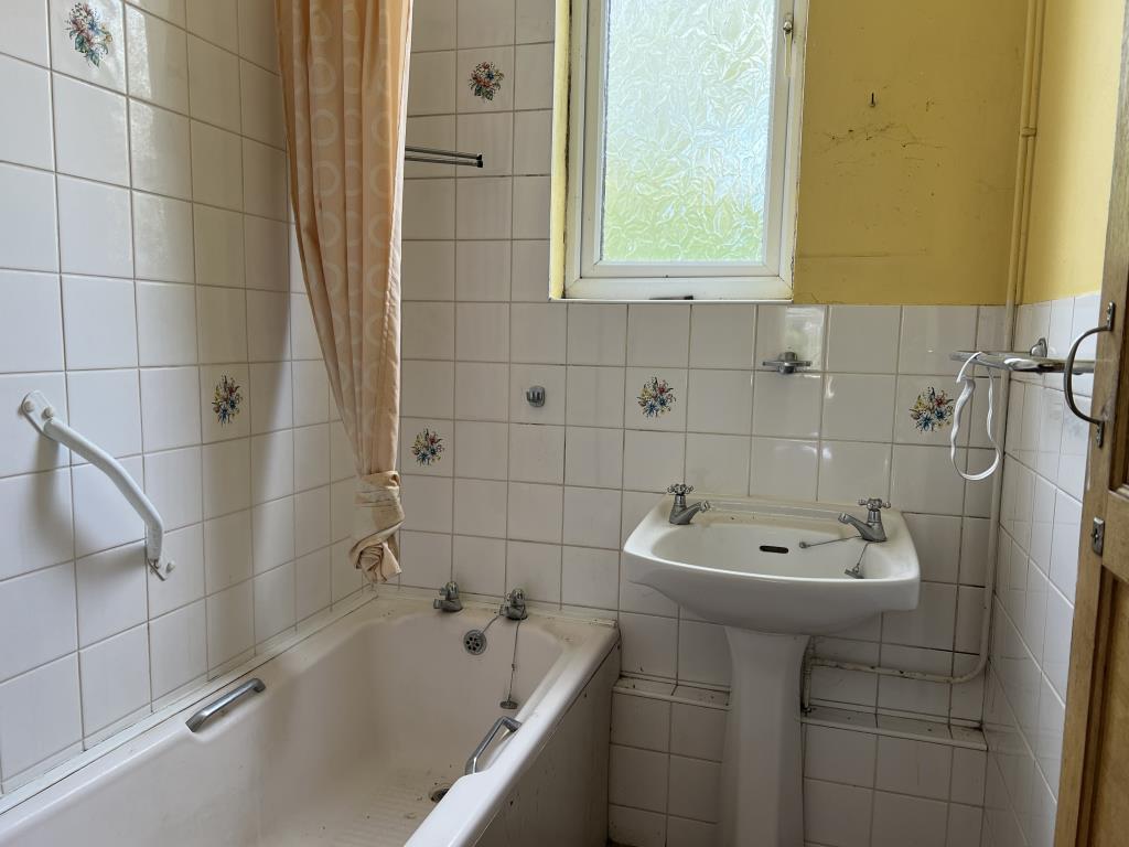 Lot: 129 - FOUR-BEDROOM HOUSE IN NEED OF IMPROVEMENT - First floor bathroom with bath and hand basin